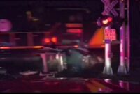 USA: Michigan firefighters rescue driver before his Jeep is crushed by a train